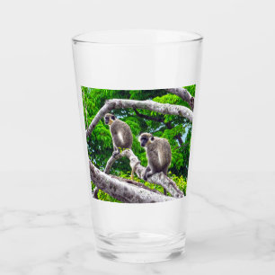 Two Green Monkeys Sitting In Tree Glass