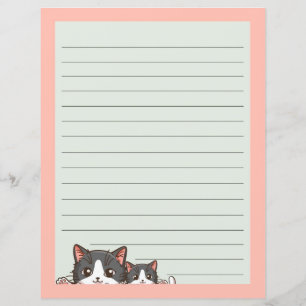 Two grey kittens on lined paper