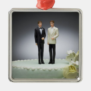 Two groom figurines on top of wedding cake metal ornament