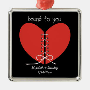 Two halves of a heart tied with a ribbon ornament