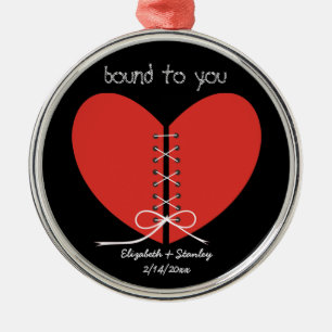 Two halves of a heart tied with a ribbon ornament