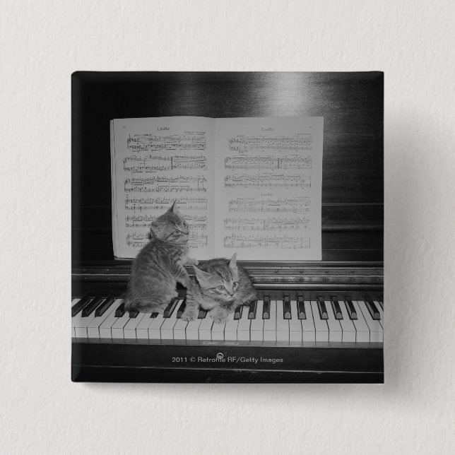 Two kittens sitting on piano keyboard by sheet 15 cm square badge (Front)