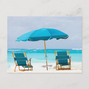 Two lounges on the ocean beach postcard