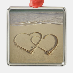Two overlying hearts drawn on the beach metal tree decoration