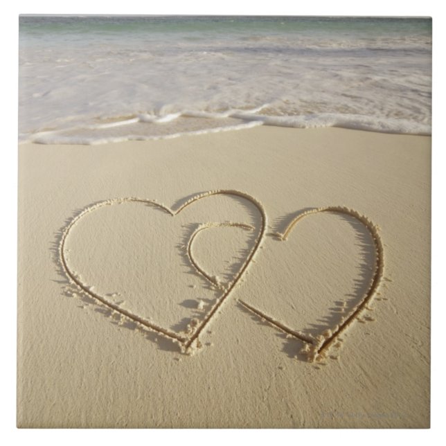 Two overlying hearts drawn on the beach with ceramic tile (Front)