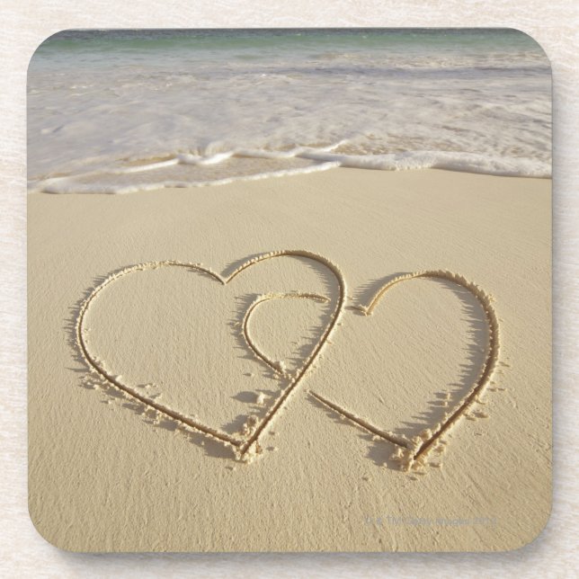 Two overlying hearts drawn on the beach with coaster (Front)