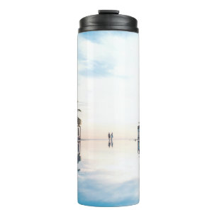 Two person standing beside swimming pool thermal tumbler