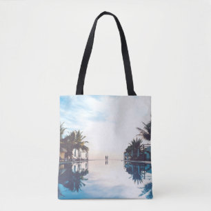 Two person standing beside swimming pool tote bag