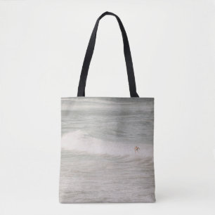 TWO PERSON SURFING ON SEA WAVES DURING DAYTIME TOTE BAG