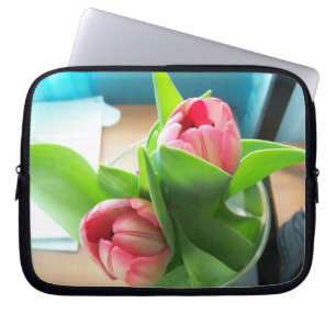 two pink tulips on a laptop sleeve