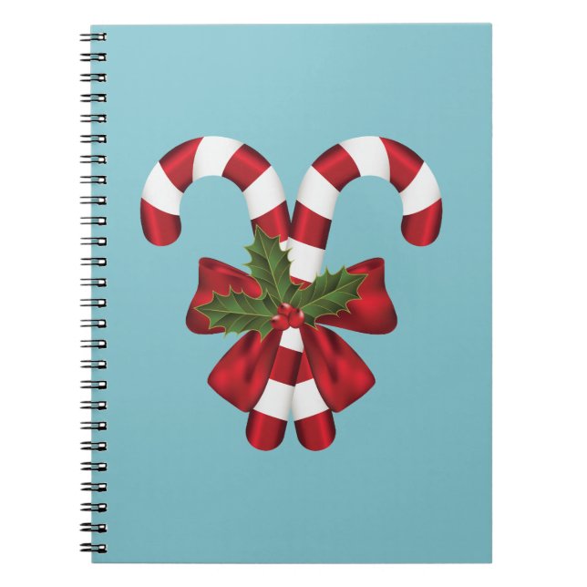 Two Red And White Festive Candy Canes On Blue Notebook (Front)