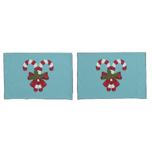 Two Red And White Festive Candy Canes On Blue Pillowcase