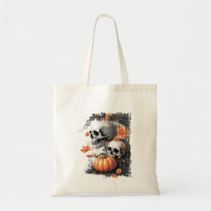 Two skulls and a pumpkin among flowers. tote bag