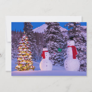 Two Snowmen Exchange Gifts by the Tree Holiday Card