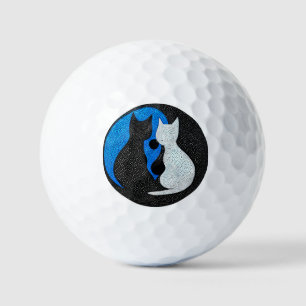 Two stylised cats golf balls