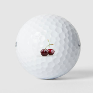 Two sweet cherry fruits isolated on white backgrou golf balls