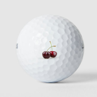 Two sweet cherry fruits isolated on white backgrou golf balls