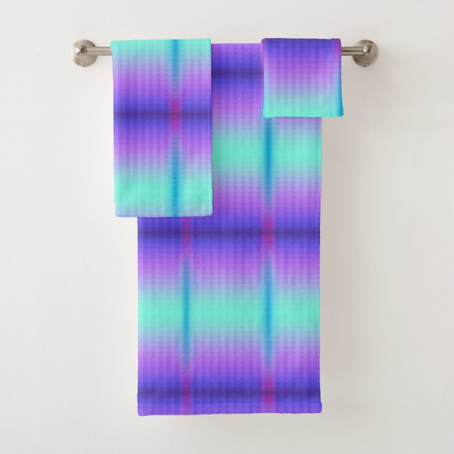 Two towels hang on a rack, featuring a gradient  (Insitu)