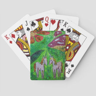 Two unicorns under a mushroom playing cards