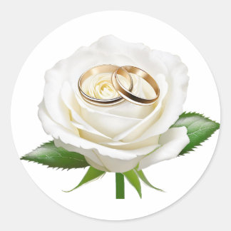 Two wedding rings on a white rose classic round sticker
