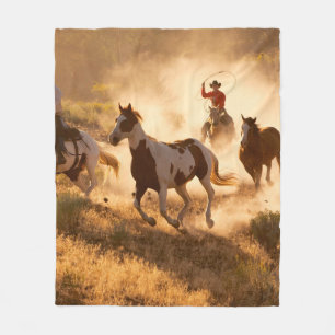 Two western cowboys riding horses, roping wild hor fleece blanket