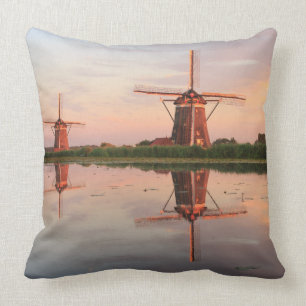 Two windmills with reflection at sunset cushion