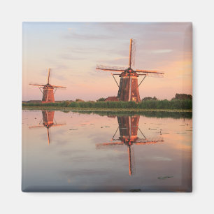 Two windmills with reflection at sunset magnet