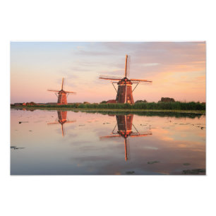 Two windmills with reflection at sunset photo print