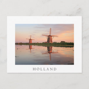 Two windmills with reflection at sunset postcard