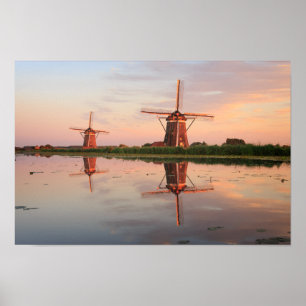 Two windmills with reflection at sunset poster