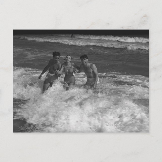 Two young men and woman playing in wave B&W Postcard (Front)