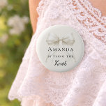 Tying the knot ivory bow pearls Bachelorette 6 Cm Round Badge<br><div class="desc">Celebrate your special milestone with this chic bachelorette party button. The design features a luxurious ivory bow adorned with delicate pearl strands. It serves as a stylish accessory for the bride-to-be to wear during her bridal shower or night out with bridesmaids. Ivory background color.</div>