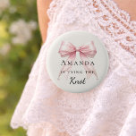 Tying the knot pink bow ivory pearls Bachelorette 6 Cm Round Badge<br><div class="desc">Celebrate your special milestone with this chic bachelorette party button. The design features a luxurious pink bow adorned with delicate pearl strands. It serves as a stylish accessory for the bride-to-be to wear during her bridal shower or night out with bridesmaids. Ivory background color.</div>