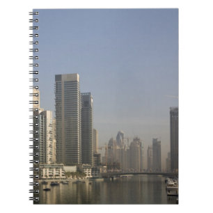 UAE, Dubai. Marina towers with boats at anchor. Notebook