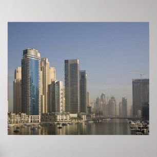 UAE, Dubai. Marina towers with boats at anchor. Poster