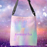Unicorn glitter drips pink purple custom monogram crossbody bag<br><div class="desc">A trendy rainbow coloured background with unicorn and rainbow pastel colours in pink,  purple,  rose gold,  mint green. Decorated with faux glitter drips in rose gold,  pink and purple. A rainbow coloured unicorn. Personalise and add a name,  written with modern block letters.   Purple coloured letters.</div>