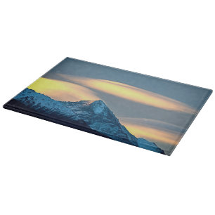 Unique Clouds Over Snow Covered Mountains Cutting Board