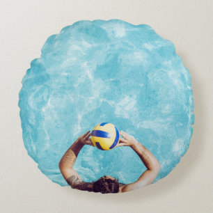 Unknown person playing beach volleyball round cushion