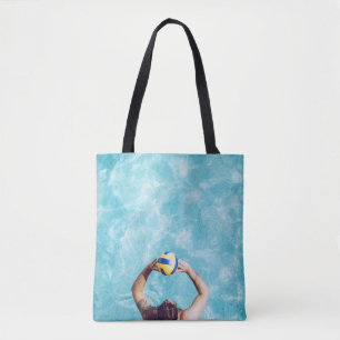 Unknown person playing beach volleyball tote bag