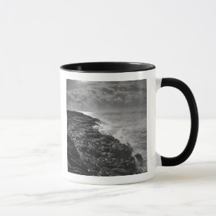 USA. Molten lava flows into the ocean at sunrise Mug