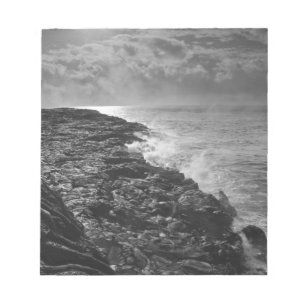 USA. Molten lava flows into the ocean at sunrise Notepad