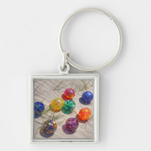 USA, Oregon. Colourful Glass Floats On Sand Dune Key Ring