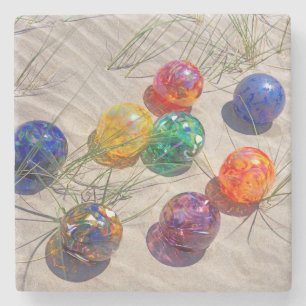 USA, Oregon. Colourful Glass Floats On Sand Dune Stone Coaster