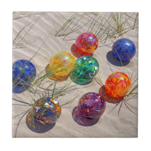USA, Oregon. Colourful Glass Floats On Sand Dune Tile