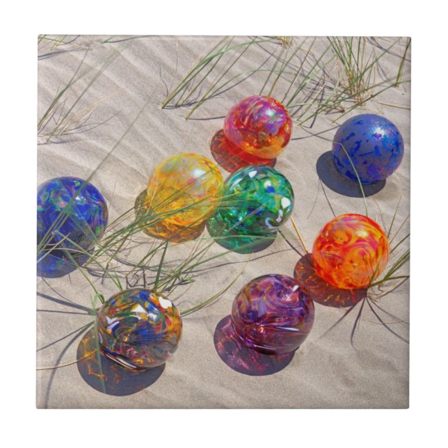 USA, Oregon. Colourful Glass Floats On Sand Dune Tile (Front)