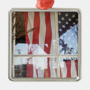 USA, Oregon, Shaniko. Flag in window next to Metal Ornament