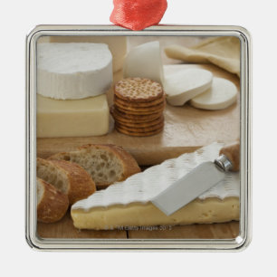 Various cheeses and bread on table metal ornament