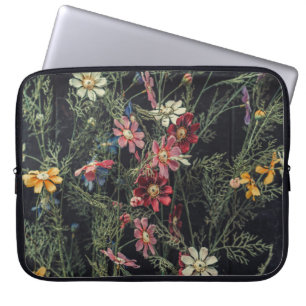 Various flowers on the black wooden background. Ab Laptop Sleeve