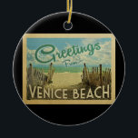 Venice Beach Vintage Travel Ceramic Ornament<br><div class="desc">This Greetings From Venice Beach vintage postcard design features a sandy beach with a beautiful turquoise ocean water and above the sea,  a blue sky with billowy white clouds. In vintage travels style.</div>