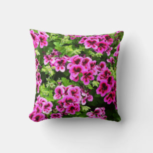 "Vibrant Blooms: Hot Pink Geraniums on Lush Bush Cushion